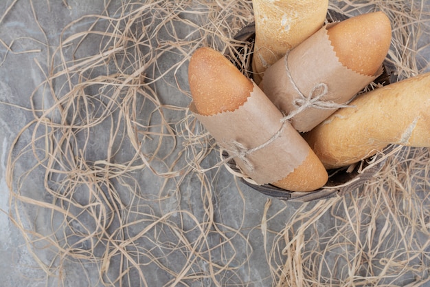 Free photo mini bread with french baguette on marble surface