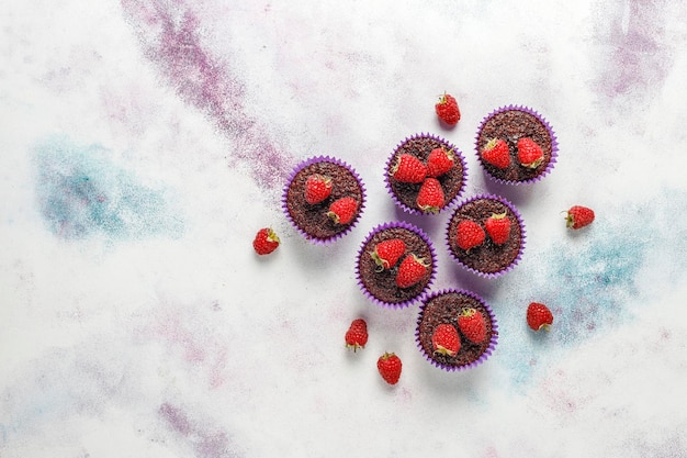 Mini chocolate souffle cupcakes with raspberries.