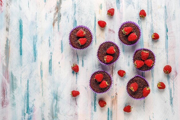 Mini chocolate sufle cupcakes with raspberries.