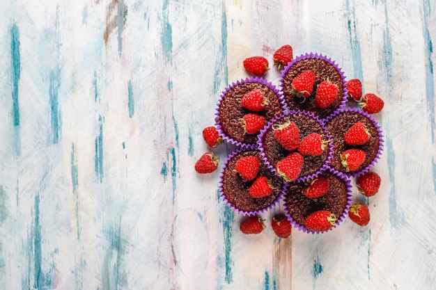 Mini chocolate sufle cupcakes with raspberries.