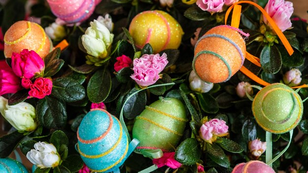 Mini Easter eggs in the flowers decorated with colorful lines