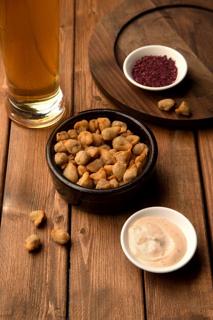 Mini fried dumplings as beer snack served with sauce and sumac