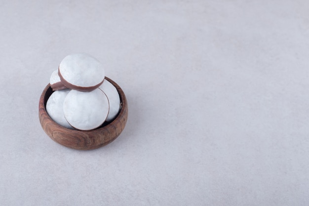 Mini mousse pastry dessert in a bowl on marble table.