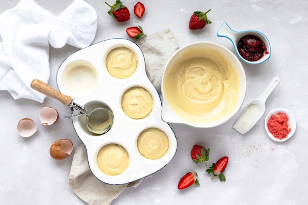 Mini strawberry cupcakes in a baking tray on a kitchen counter