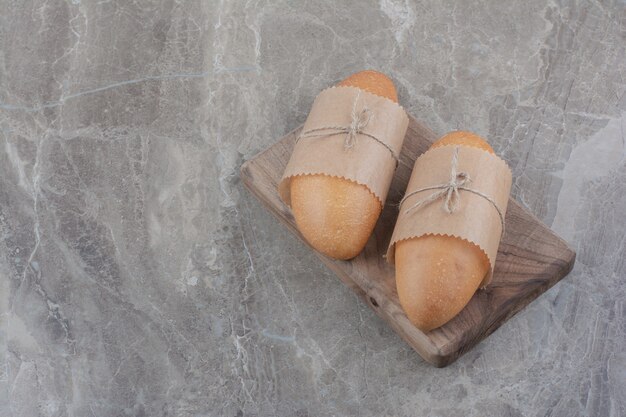 Mini white bread on wooden board