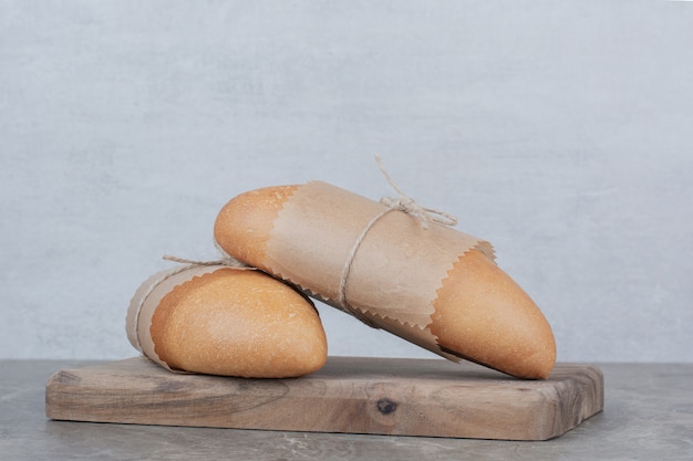 Mini white bread on wooden board