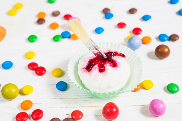 Mini white muffin between little colourful candies