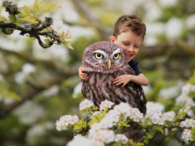 Free photo miniature adventure with boy hugging owl