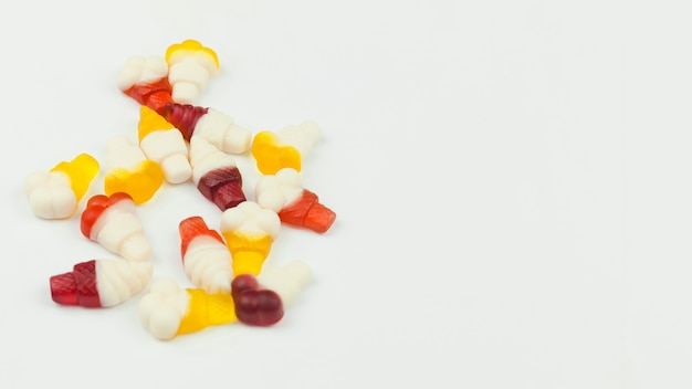 Miniature gummy candies in form of ice cream on light background