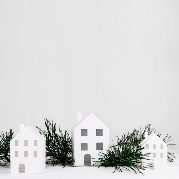 Miniature houses with fir branch