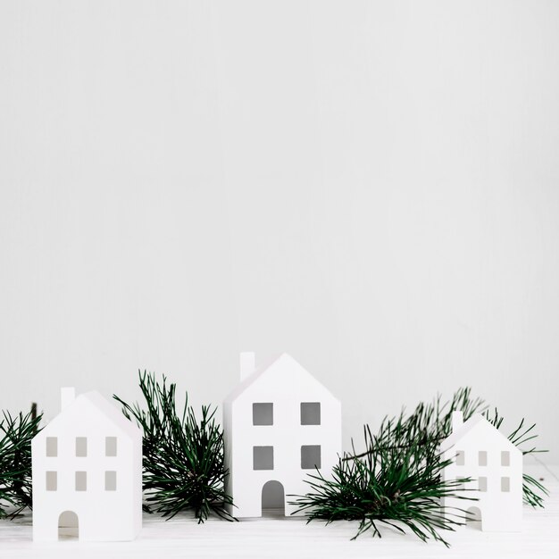 Miniature houses with fir branch