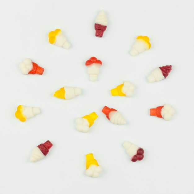 Miniature ice cream figures on light background