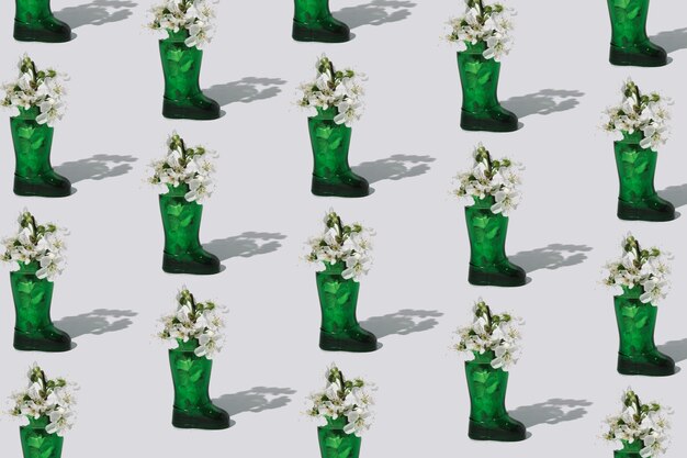 Minimal fashion concept with green boot and spring flowers sustainability idea summer pattern idea