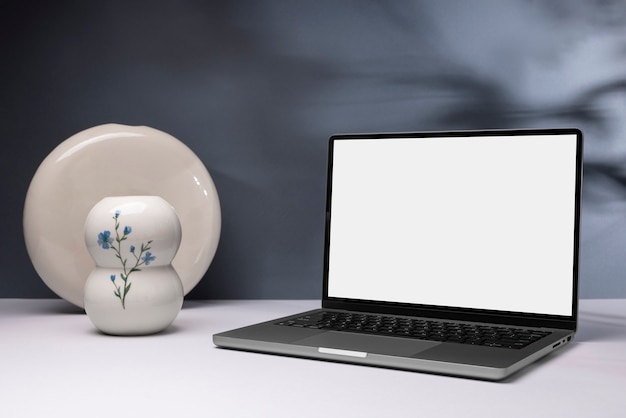 Minimal laptop and flower vase