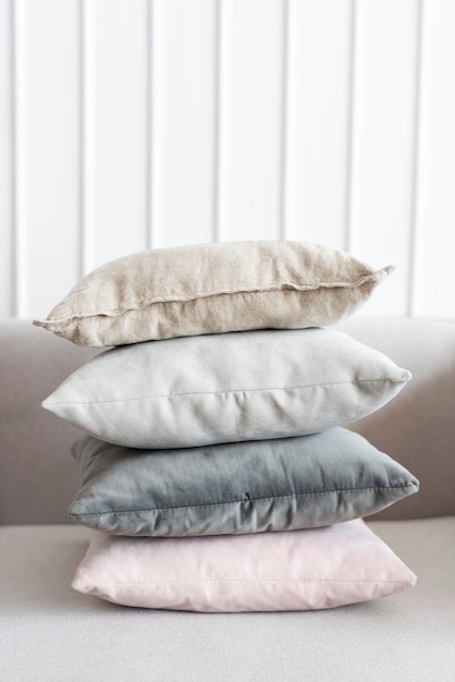 Free photo minimal linen cushion covers on a sofa