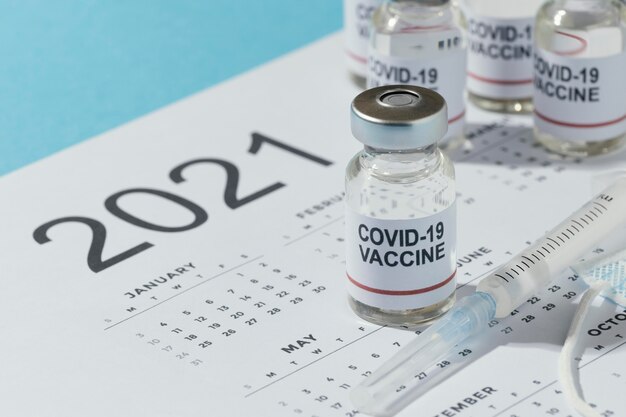 Minimal vaccine bottles composition on calendar