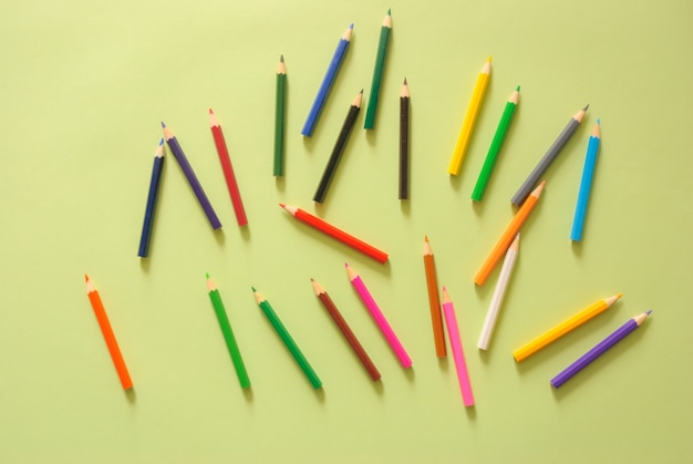 Minimal work space - Creative flat lay photo of workspace desk with color pencil on copy space green pastel background. Top view , flat lay photography.