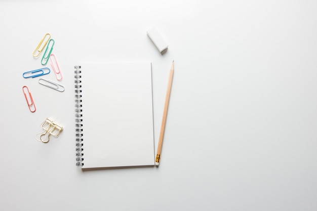 Minimal work space - Creative flat lay photo of workspace desk with sketchbook and wooden pencil on copy space white background. Top view , flat lay photography.