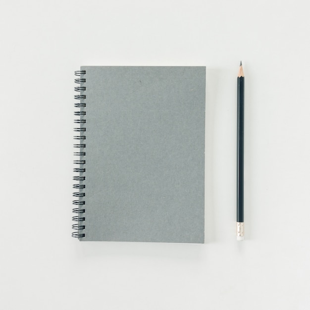 Minimal work space - Creative flat lay photo of workspace desk with sketchbook and wooden pencil on copy space white background. Top view , flat lay photography.