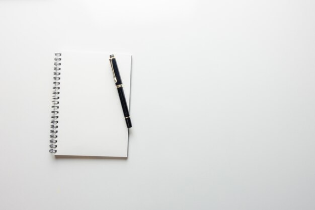 Minimal work space - Creative flat lay photo of workspace desk with sketchbook and wooden pencil on copy space white background. Top view , flat lay photography.