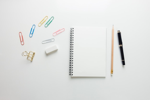 Minimal work space - Creative flat lay photo of workspace desk with sketchbook and wooden pencil on copy space white background. Top view , flat lay photography.