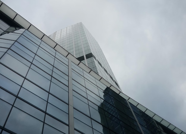 Minimalist architectural photo of steel and glass building in cloudy weather