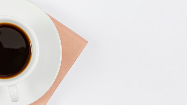 Minimalist composition on office desk with cup of coffee