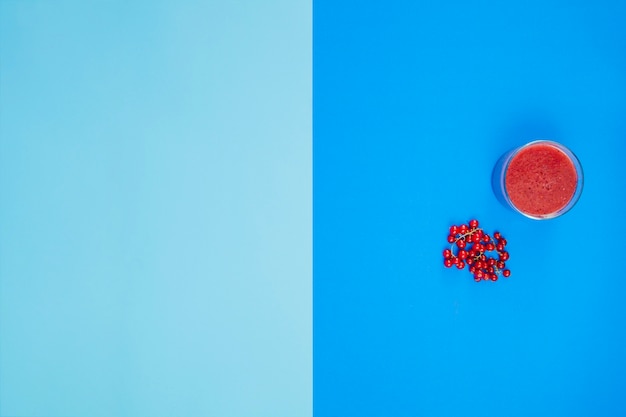 Minimalist composition with red fruits and juice