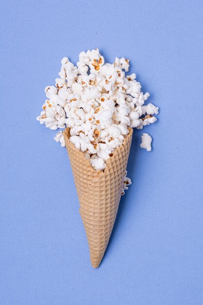 Minimalist concept of salted popcorn on ice cream cone