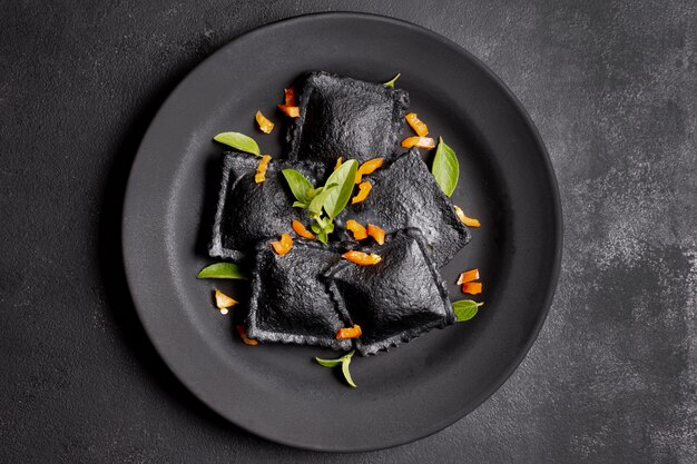 Minimalist flat lay black ravioli on plate
