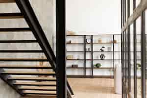 Free photo minimalist modern book shelf and stairs