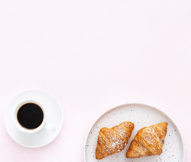 Minimalist plate with french croissants and coffee