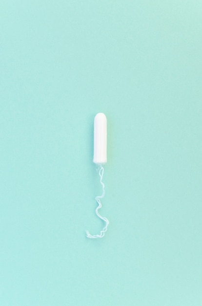 Minimalist tampon on blue background top view
