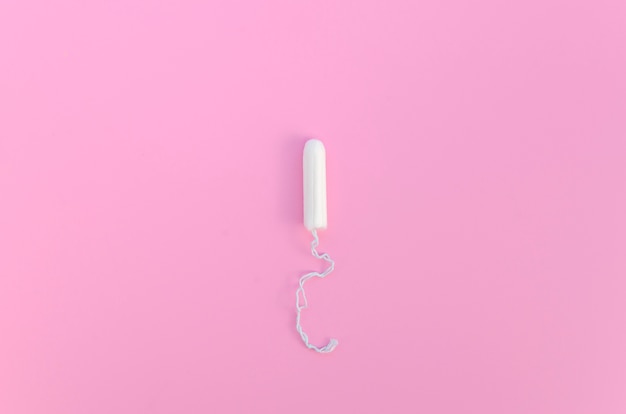 Minimalist tampon on pink background top view
