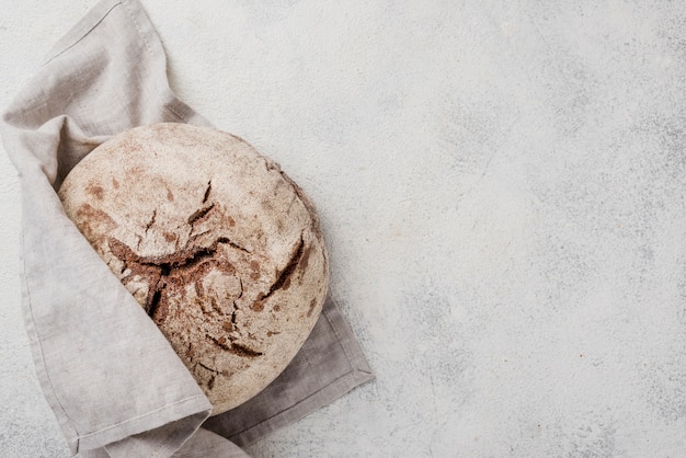 Minimalist whole bread wrapped in white cloth