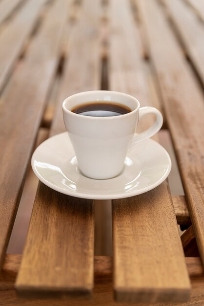 Minimalistic coffee cup on wooden table