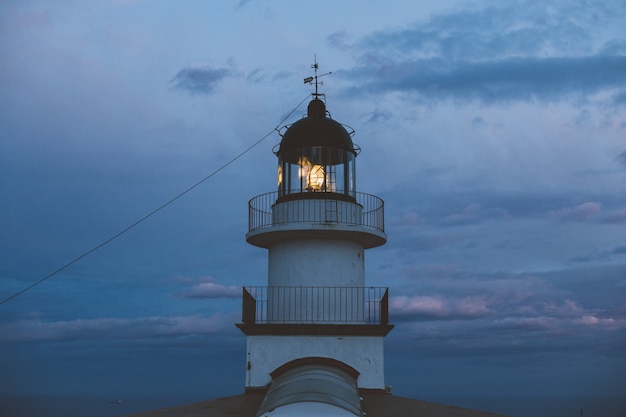 Minimalistic and geometrical symmetry shot of beautiful vintage lighthouse on top of cliff
