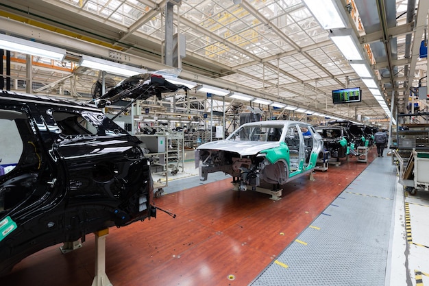 Minsk Belarus Dec 15 2021 Car bodies are on assembly line Factory for production of cars Modern automotive industry A car being checked before being painted in a hightech enterprise