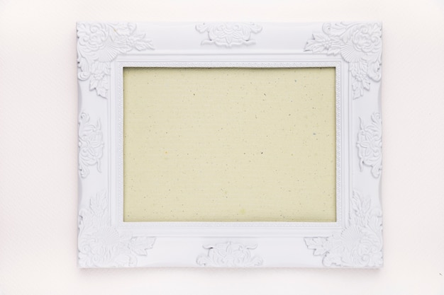 Mint green frame with white floral wooden border isolated on white backdrop