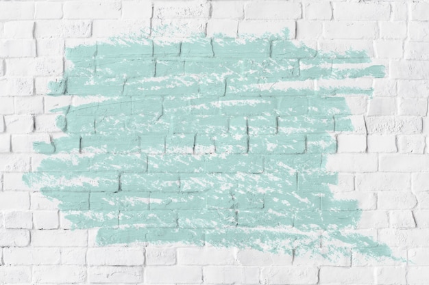 Free photo mint green oil paint texture on a white brick wall