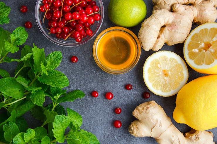 Free Photo mint leaves with lemons, ginger, honey, redcurrant top view