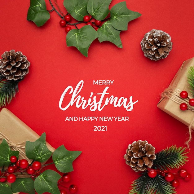 Free Photo mistletoe, pine cones and gifts on red table christmas greeting