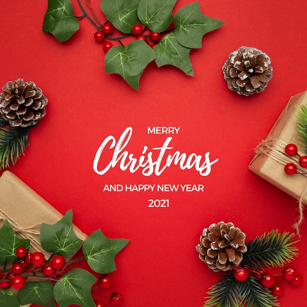 Mistletoe, pine cones and gifts on red table Christmas greeting