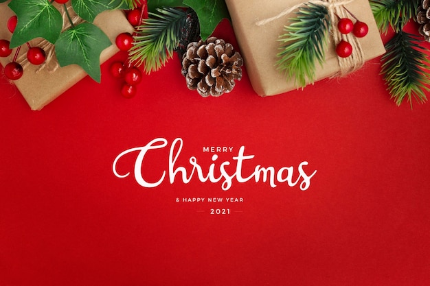 Free photo mistletoe, pine cones and gifts on red table christmas greeting