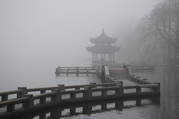 Misty landscape with wooden construction