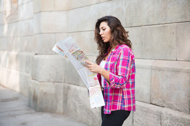 Misunderstanding girl looking at map of city