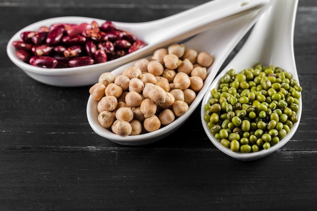 Free photo mix of beans on wooden table