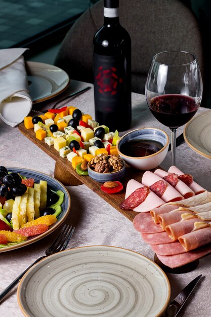 Mix of cheeses and sausages on a wooden board