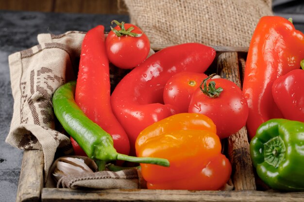 Mix of hot chili peppers in a rustic tray. Top view.