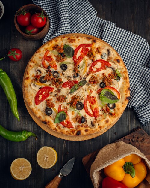 mix pizza with tomato slices, mushroom, olive